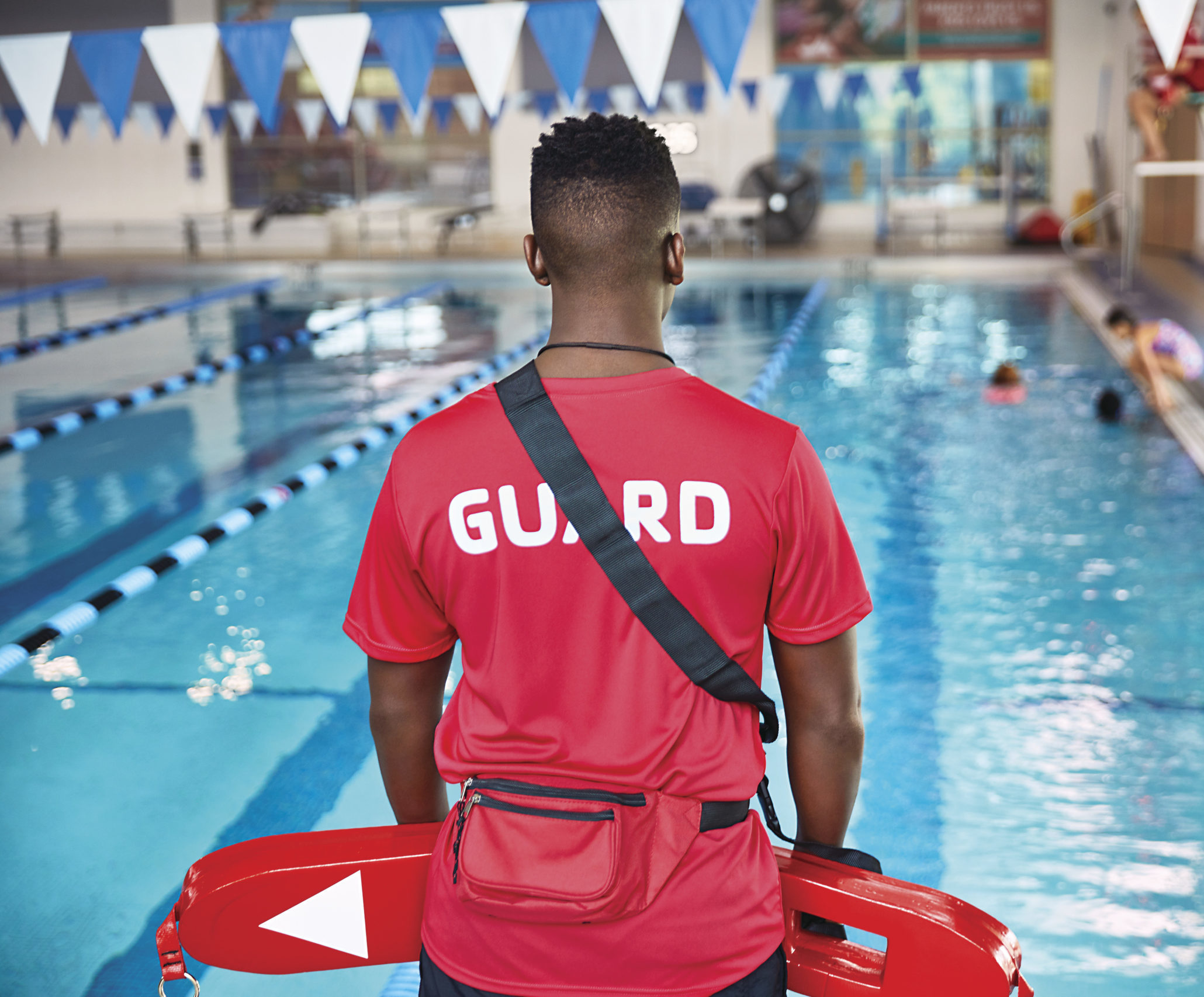 Image of lifeguard actively watching over pool
