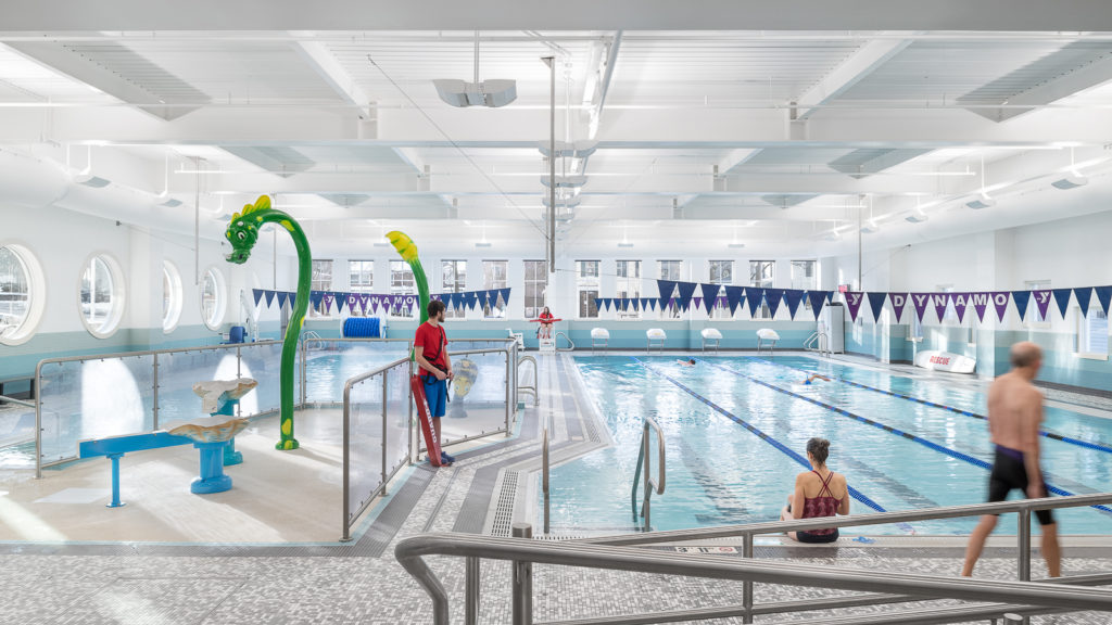 GBYMCA Aquatic Center showing both pools and splash pad, with two lifeguards watching over