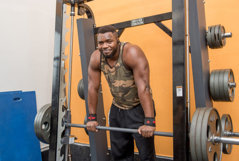 Flori, a young male from the Congo, gets ready to lift a heavy barbell