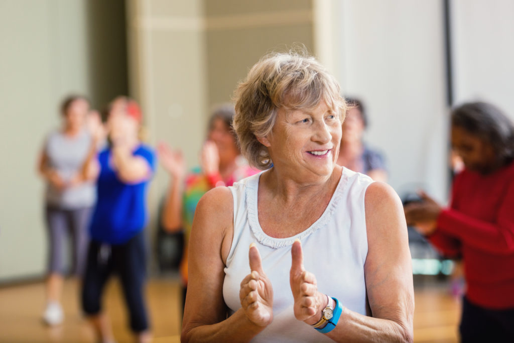 Closeup of older woman in Group Exercise class